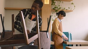 Free stock video - Waitress cleaning coffee shop table with disinfectant spray and rag while waiter raising chair to arrange in preparation for closing coffee shop