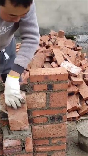 Smoothing a rough concrete wall surface using an electric sander with vacuum attachment clean finish