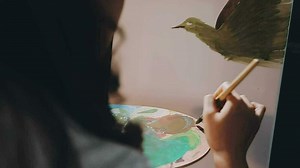 Attractive young woman attending a painting workshop, having fun, create an inspired art work at art studio