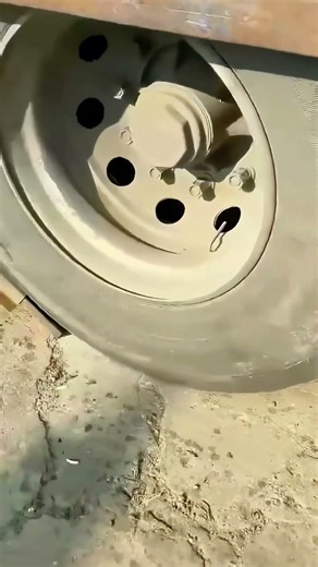 Truck tire stuck between two steel plates, should you go forward or reverse?