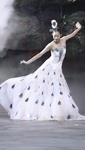 14K views · 223 reactions | A fashion show in the capital featuring a traditional peacock dance by China's ethnic Dai group enthralled audiences as the model took the runway by storm with the eyes on the bird's tail feathers beautifully represented on her dress as she elegantly performed this ancient custom. #FunChina | China Plus Culture | Facebook