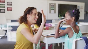 Premium stock video - Video of happy caucasian female teacher clapping hands with african american girl during lessons