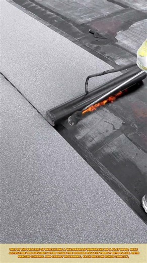 Skilled Worker Installing Waterproof Roof Membrane Using Heat Torch and Roller