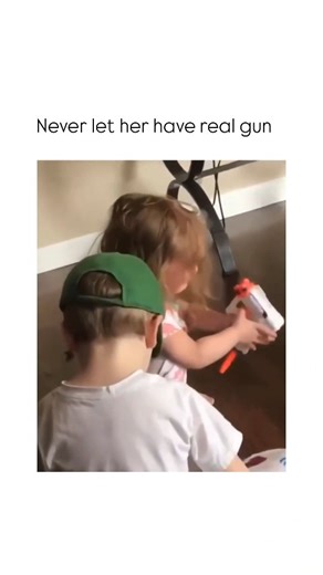 Brutal Humors on Instagram: "This video captures a short, relatable moment where a young girl attempts to find a way to express her frustration during a play-related meltdown. ​The Subject ​A young girl in a colorful top is sitting on a wooden floor, crying intensely. A young boy wearing a white shirt and a green baseball cap sits nearby, watching her. In front of her is a toy, which appears to be a white and orange toy blaster, lying on the floor. ​The Mechanism ​As the girl continues to cry, s