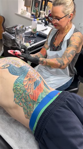 This is Will, and this is Will's only tattoo. A couple of years ago, I painted a peacock that Will fell in love with. He visited me, feeling nervous and unsure, and after some long thought, he decided to take the plunge. Getting a backpiece as your first tattoo is a massive commitment - it demands dedication, trust, and mental toughness. Lucky for me, Will's got all that in spades. We've almost finished his back, and now he's asking to add his legs to the design. This is one of my all time favou