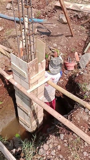 installation of column formwork for stone foundation base.
