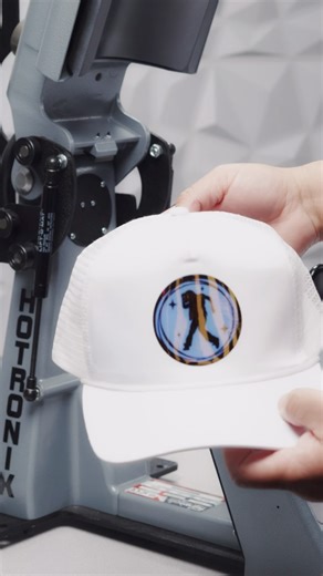 HeatPressNation.com on Instagram: "Watch how we combine Siser Holographic with EasyWeed to create a layered design that pops! From dialed-in cut settings on the Siser Juliet to pro-level precision with the Hotronix 360 IQ cap press—this project is all about clean layers and bold finishes."