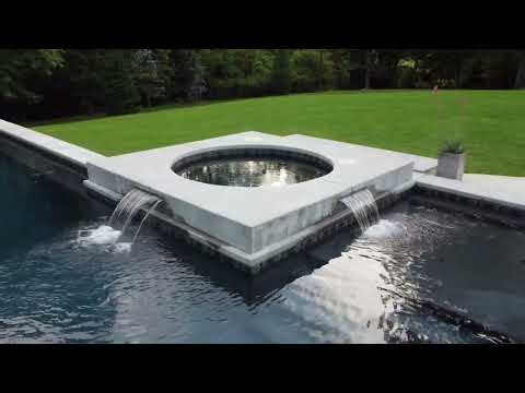 Why Every Luxury Pool Needs a Sheer Decent or Rock Waterfall