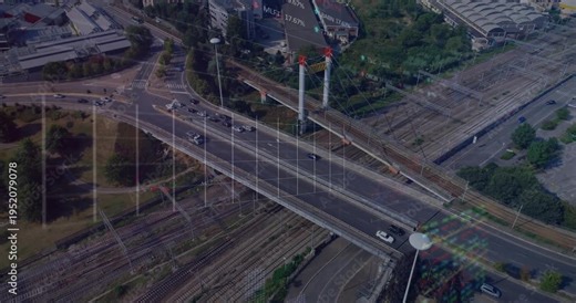 Camera shifting, bridge crossing rail yard, cars moving, finance graphs rising, visualizing traffic