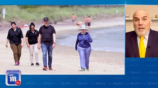The Clintons take a walk on the beach in the Hamptons