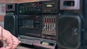 A Hand Inserts the Cassette into the Old Cassette Player and Plays it by Pressing the Play Button Footage.