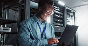 Happy man, technician and laptop in server room for database update, cyber security or code. Computer, smile and African engineer in data center for information technology, typing and programming