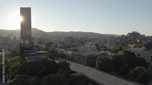 Drone aerial shot over a city downtown: Soaring above towering skyscrapers, winding streets, and bustling citylife, this captivating drone footage offers a unique perspective of the urban landscape's
