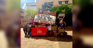 Texas State University students, staff rally in support of former professor