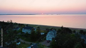 Beautiful Beach Sunrise in Saco Maine with Vacation Homes and Colors Reflecting off Ocean Waves Along the New England Atlantic Coastline. Aerial Drone View of Colorful Golder Hour Sky and Sea Water