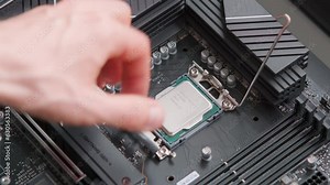 Man removing a CPU from a motherboard. Computer hardware. Close up