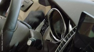 Car wash and detailing. A man cleaning the car interior of luxury modern automobile. 4K