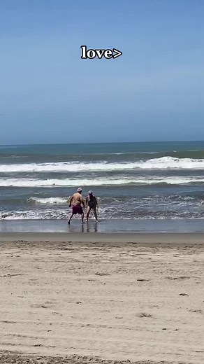 Elderly Couple Enjoying Playful Beach Time Together