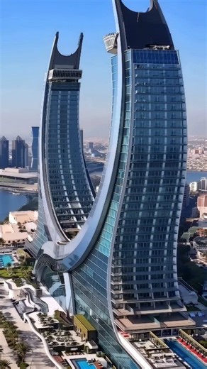 Raffles doha is located within the Katara Towers, inspired by the crossed swords of Qatar. This modern-day masterpiece is the symbol of a new Doha. Embark on your bespoke journey of discovery in one of the highly personalised suites, where innovative luxury is brought to life in the most dazzling of ways. Raffles Hotels & Resorts #luxury #travel #hotel #qatar | Hotels Resorts and Cruiseships