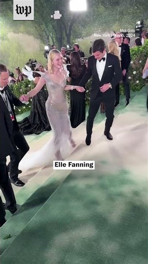 Elle Fanning side steps her way up Met Gala steps