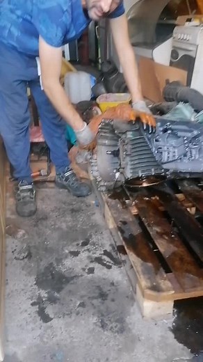 Mechanic Repairing Engine Components in Workshop