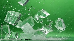 Ice cubes explode on a green screen, creating a refreshing splash. Perfect for summer designs, the dynamic image adds a unique touch to creative projects