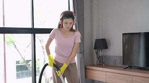 clip-1104635233-woman-cleaning-house-using-mop-living-room