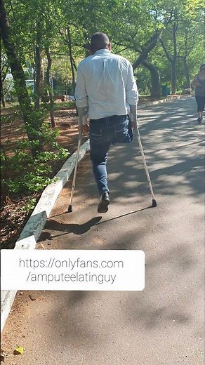 Amputee guy walking around with crutches