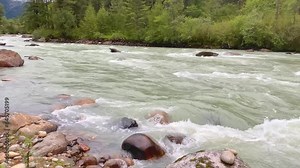 View of a river flowing in a valley surrounded by greenery with mountains in Bumthang district of Bhutan Stock Video