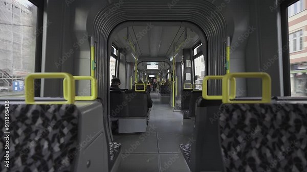 Berlin streetcar interior during the ride. Theme electric rail public transportation in Berlin, Germany. Interior view of Berlin streetcar, empty compartment. Strassenbahn in Berlin Innenaufnahme.