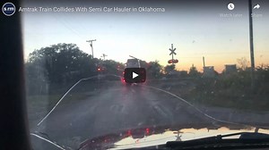 Watch: Train collides with semi car-hauler stuck on tracks