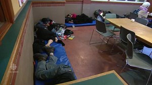 Volunteers and patrons work around sleeping meth addicts every day