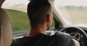 Man driver driving his car, back view