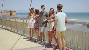 Group of teens hanging out near beach