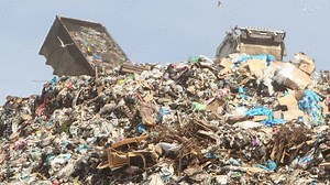 Dump trucks dump garbage in a huge pile