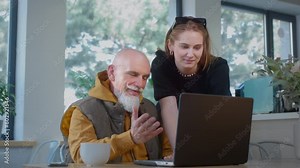 Stylish grandpa works in a cafe with a laptop. Oldman freelancer does networking with a colleague of a young girl in a cafe or restaurant. Remote work on an IT project. Esg Chat GPT, Global Growth