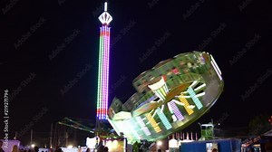 The Great Geauga Fair in Ohio. Carnival rides and night lights streaking across a dark sky. Ferris wheel, rotor, scrambler, and more. Stock Video