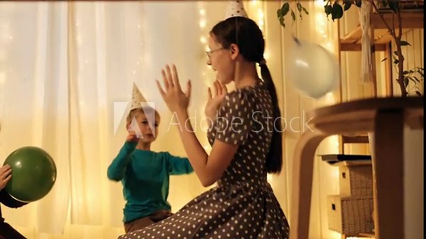 Family Fun Children Joyfully Blowing Up Balloons. Kids inflating balloons, prepare for birthday party. 3,6, 14 years old siblings racing blowing balloon, decorate the room. Bonding time together. Joy