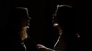 Two girls combing hair