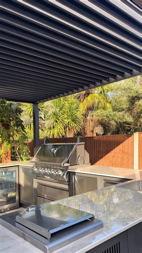 AOS Outdoor Kitchens ltd on Instagram: "Take a closer look at this impressive U-shaped outdoor kitchen — a fully equipped cooking space built for all-weather living and modern garden design. Set beneath a Nova Titan pergola, this setup uses the Napoleon Oasis modular range to create a clean, streamlined layout that works perfectly for hosting, cooking, and everyday outdoor living. From high-heat grilling on the Napoleon Prestige Pro 665 to simmering sides on the dedicated burner, everything is d
