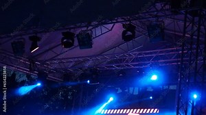 The result of work of lighting engineer at a concert. Soffits, ramp, blinder, parabolic aluminum reflectors. Multi-colored highlights and rays shine alternately. Lighting design for the concert stage