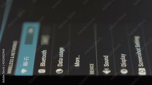 Smartphone connecting to WiFi. Tablet lying on a table connects to wifi. Close up.