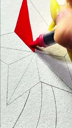 Coloring geometric pattern with orange marker on textured paper