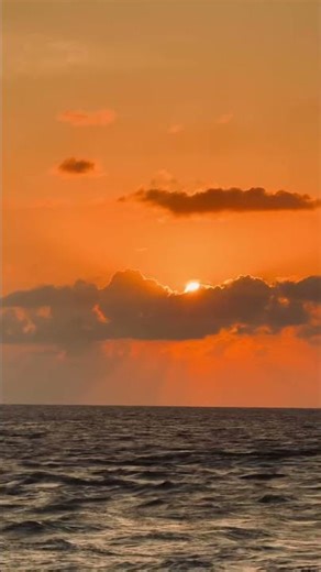 Sunset Behind Clouds by the Sea – Peaceful Coastal Glow