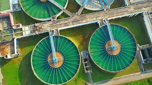 Drones are flying over water treatment plants, wastewater treatment ponds to remove chemicals and contaminants. tap water industry for consumption. pure drinking water concept. 4K