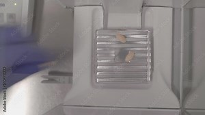 Close up 4k shot of hands of scientist testing white medical pills under light in a modern phrmaceutical manufacturing plant. Quality test procedure. Medicine, science and drug production concept.