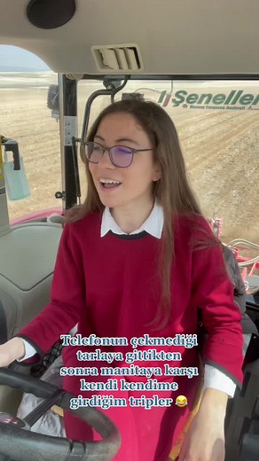 Young Woman Driving Tractor in the Rain
