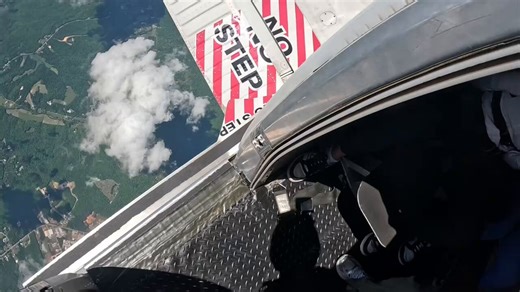 This skydiver steps out the open door of the plane thousands of feet up and immediately starts freefalling with arms and legs spread wide.The camera follows the long drop as the ground and clouds spin below while the diver tumbles and stabilizes with the massive landscape rushing up fast.You watch someone willingly jump from a plane and trust the freefall before the parachute even opens. Do you think it is an incredible adrenaline experience worth the extreme risk or do you say jumping out of a