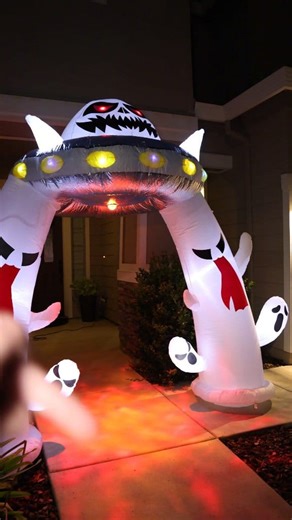 I am absolutely obsessed with how my front yard looks for Halloween this year, and it's all thanks to this one decoration. I wanted to create a full scene, and this giant inflatable alien abduction arch was the perfect centerpiece! ​The level of detail is fantastic. You have this massive UFO with a spooky alien pilot inside whose eyes glow a menacing red. The ship itself is lit up with vibrant, flashing LED lights that make it look like it just landed. It's easily the first thing you notice from