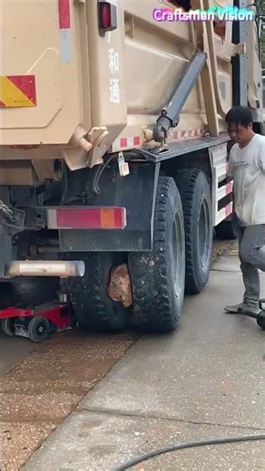 This is the wrong way to remove a stone stuck in the rear wheel of a muck truck!
